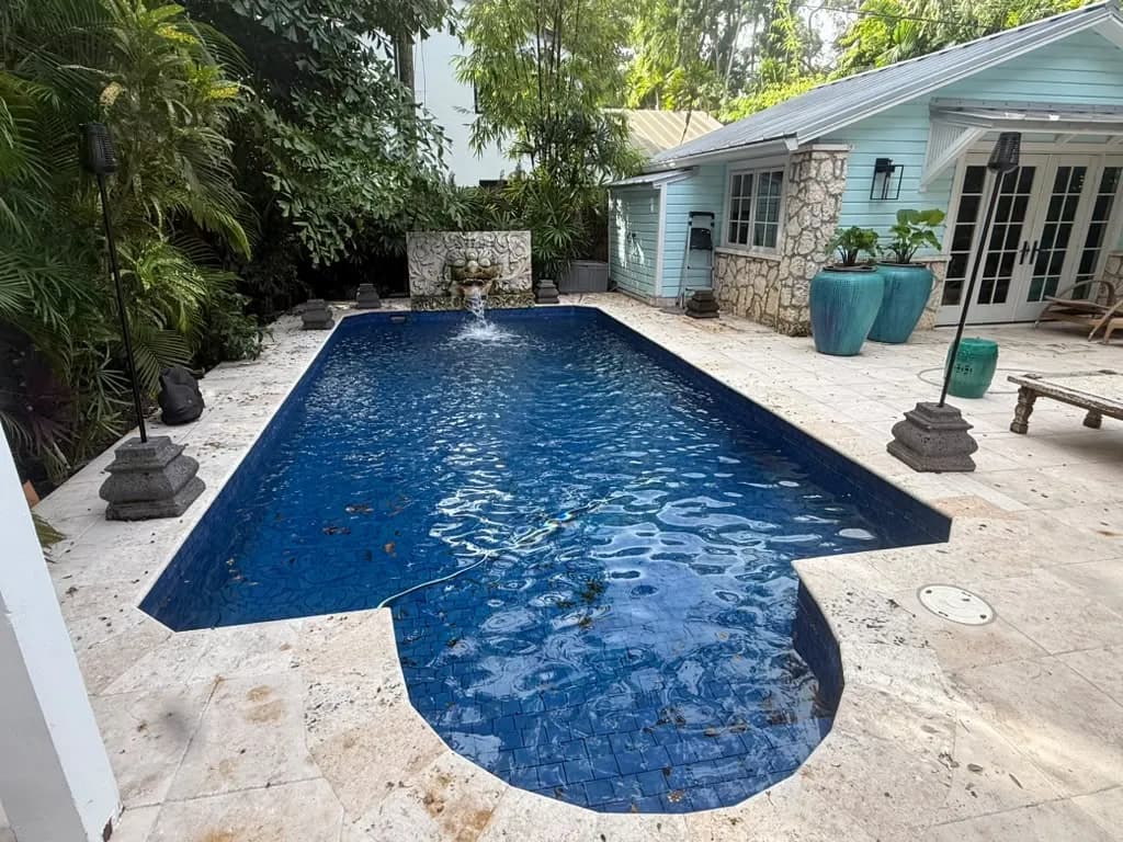 Travertine pool deck with dirt and stains before pressure cleaning