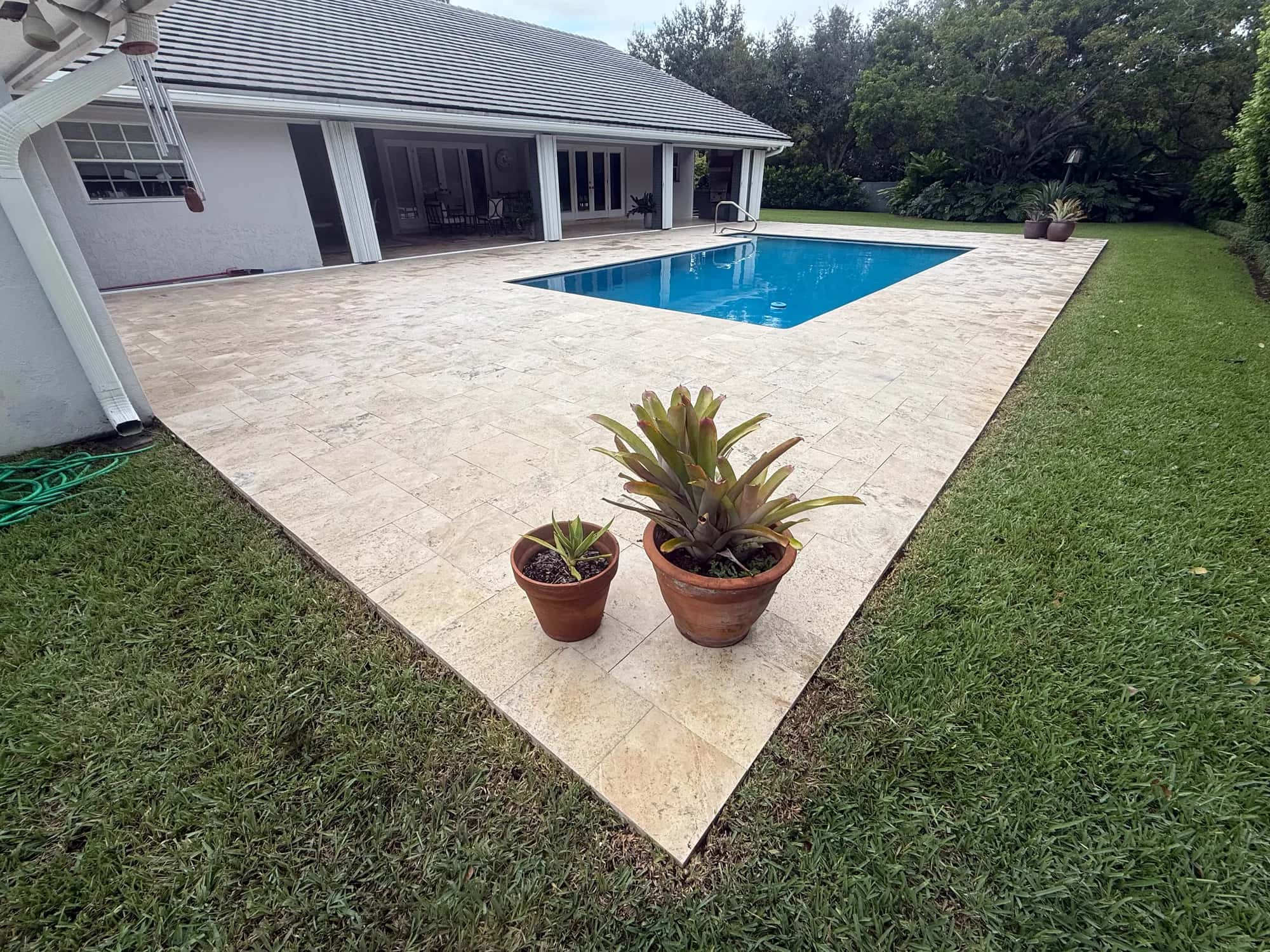 Bright white travertine pool deck after pressure cleaning